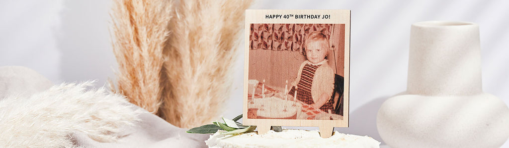 Retro photo of a young girl with the caption 'Happy 40th Birthday Jo' - the photo is standing on top of a birthday cake