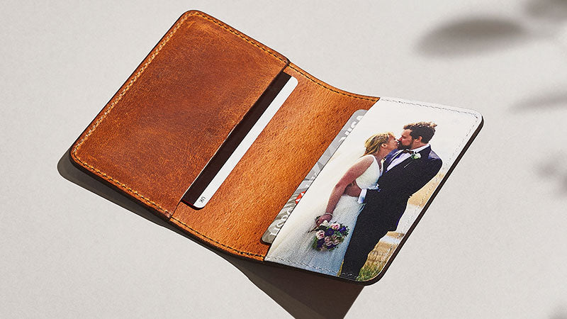 A leather wallet with a photo of a bride and groom printed inside
