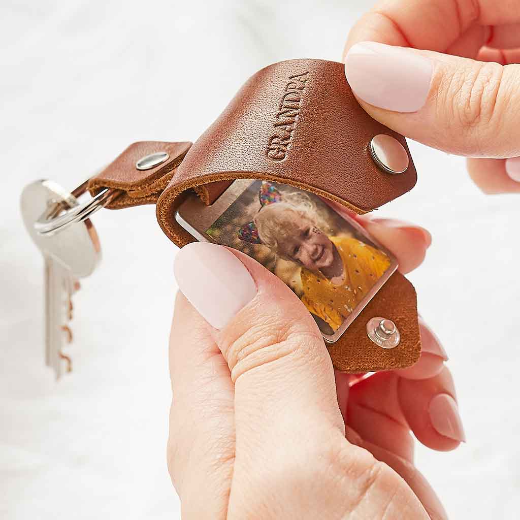 Leather keyring with a child's photo printed inside, stamped with 'Grandpa'