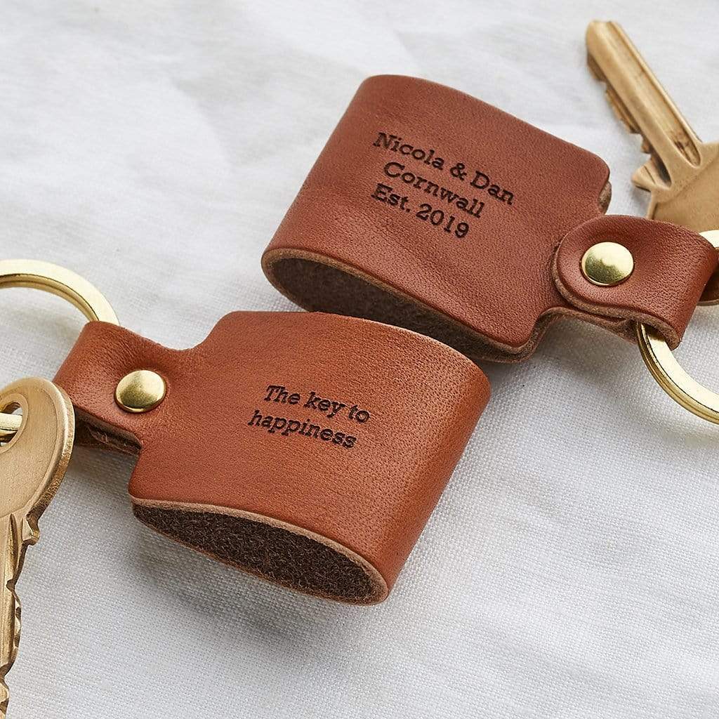 Brown leather keyrings engraved 'The key to happiness'