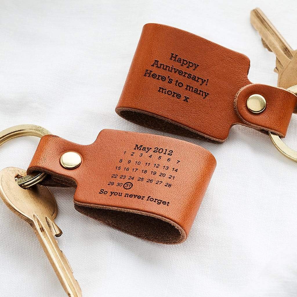 Two leather keyrings engraved with messages and calendars