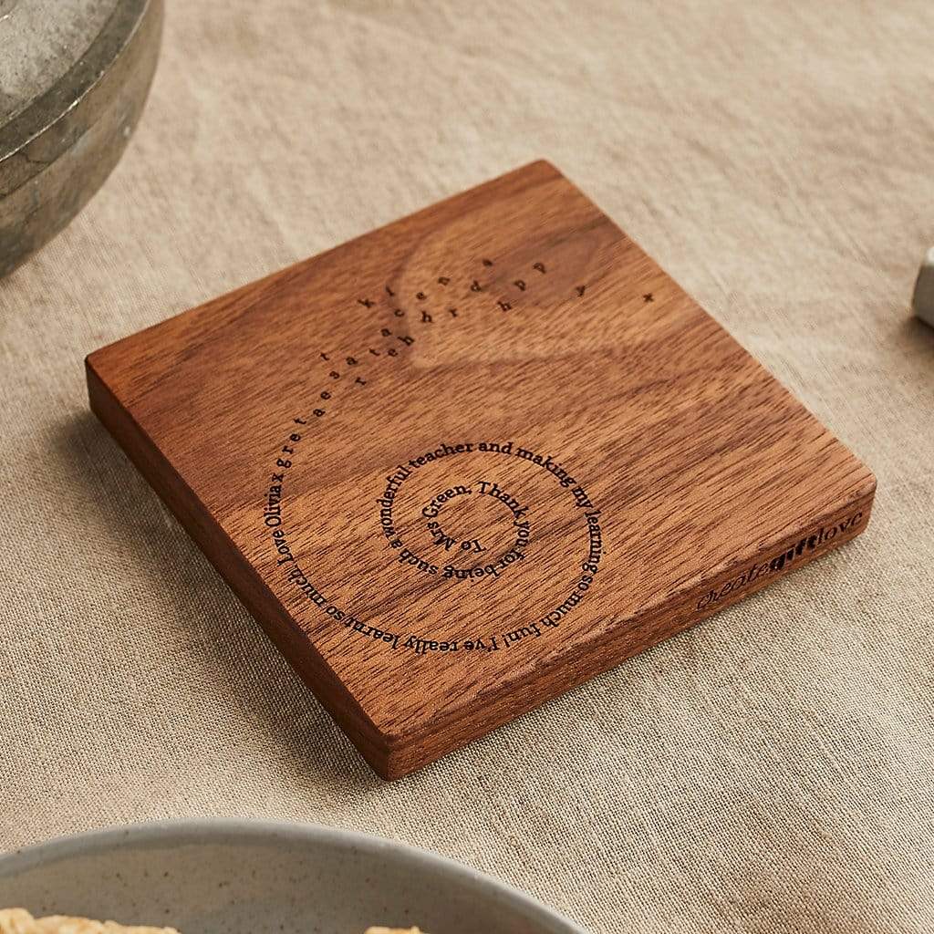 Wooden coaster with a personalised teacher message engraved in a spiral shape