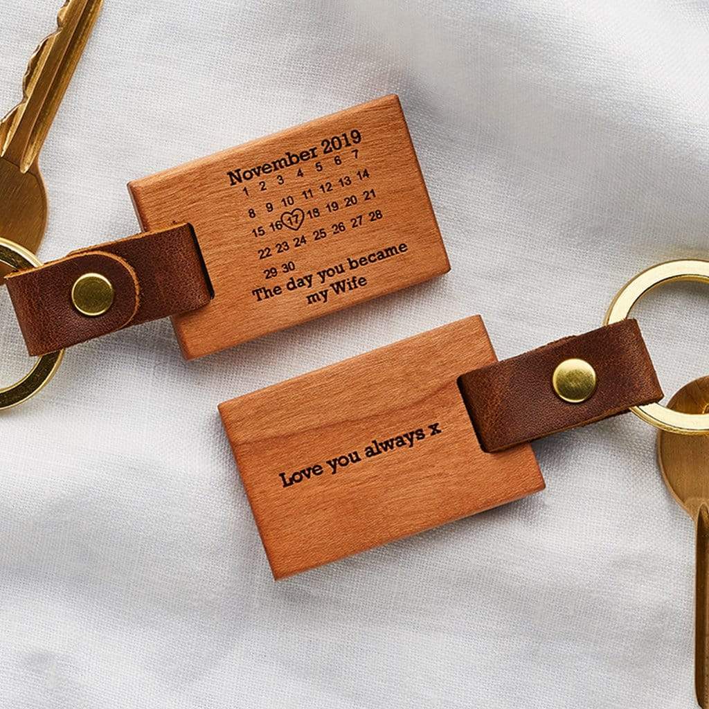 Two wooden keyrings engraved with calendar design and personalised messages