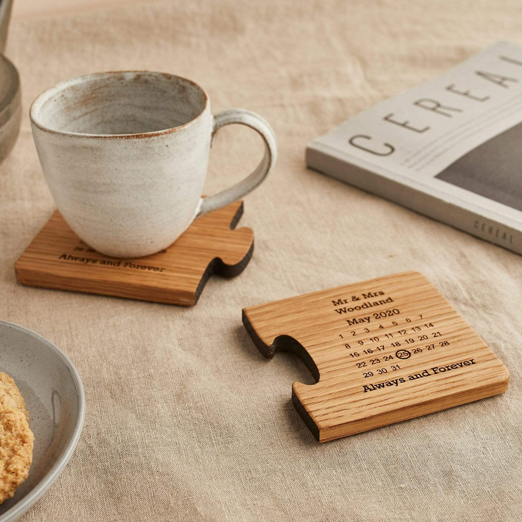 Wooden coasters engraved with a calendar design, shown with a mug and magazine