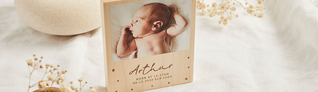 Wooden block printed with a photo of a baby and engraved with the name 'Arthur'