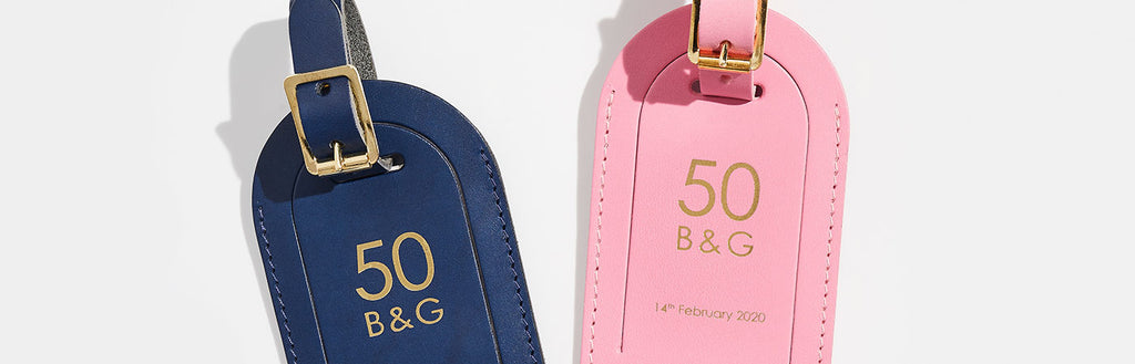 Leather luggage tags in blue and pink, stamped '50 B&G' in gold - Create Gift Love corporate