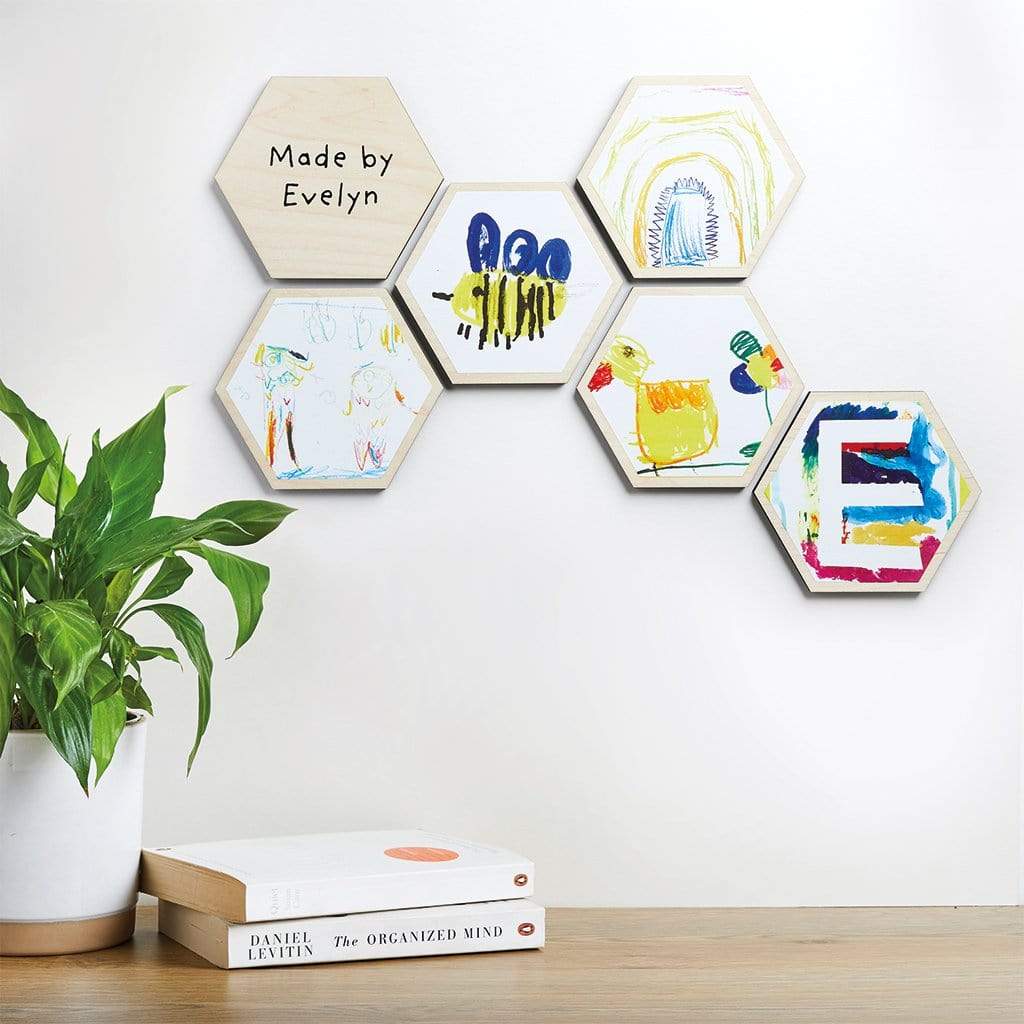 5 x children's drawings displayed on the wall, printed onto wooden hexagon tiles