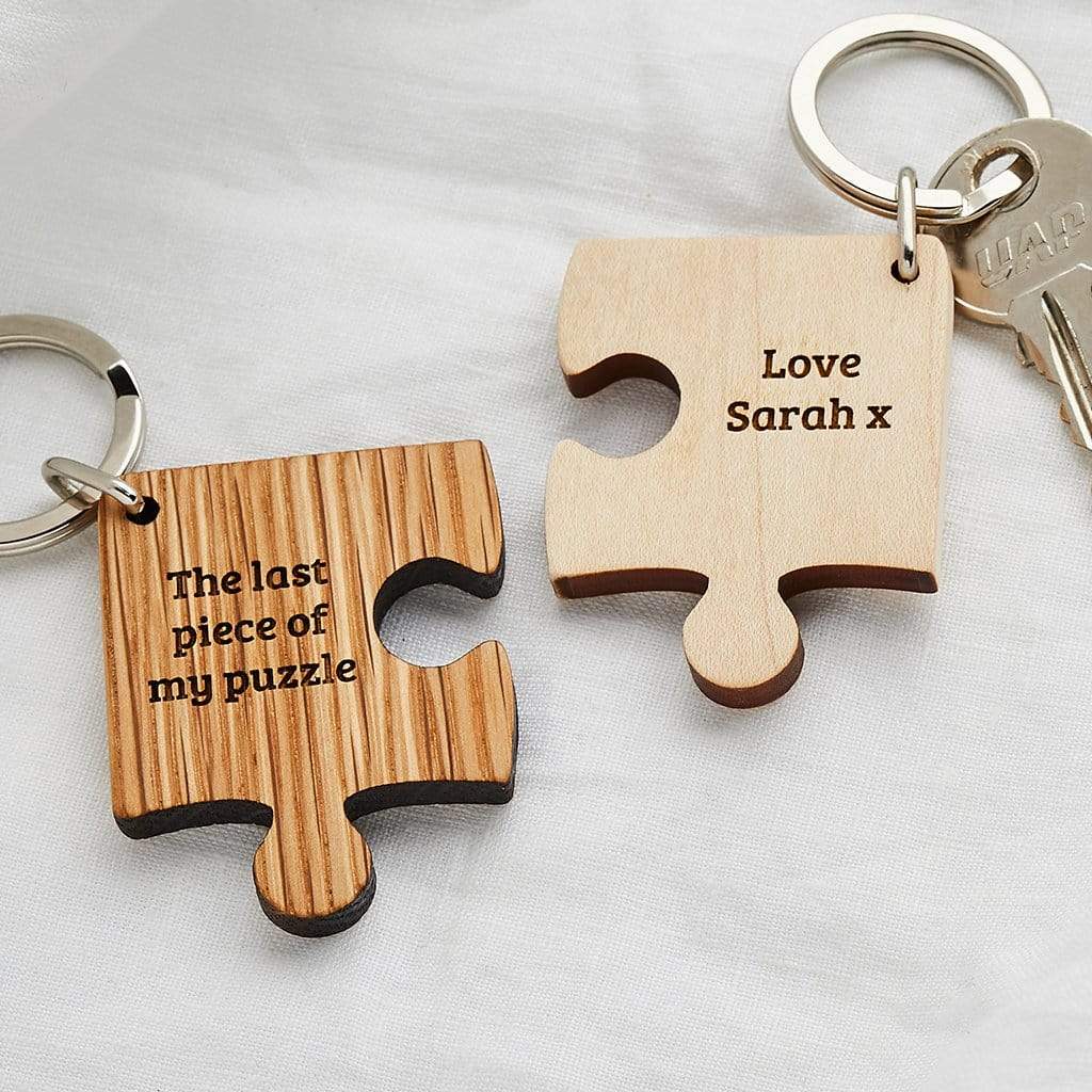Two wooden jigsaw shaped keyrings with personalised messages