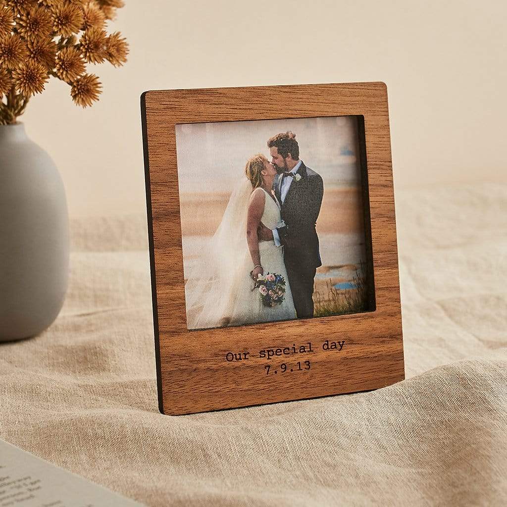 Wooden photo frame engraved with wedding date, showing a photo of bride and groom
