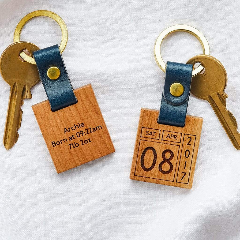Two wooden keyrings engraved with a retro calendar design
