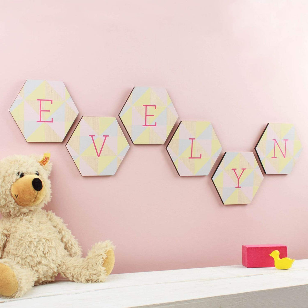 Pink nursery wall with personalised 'Evelyn' wall tiles