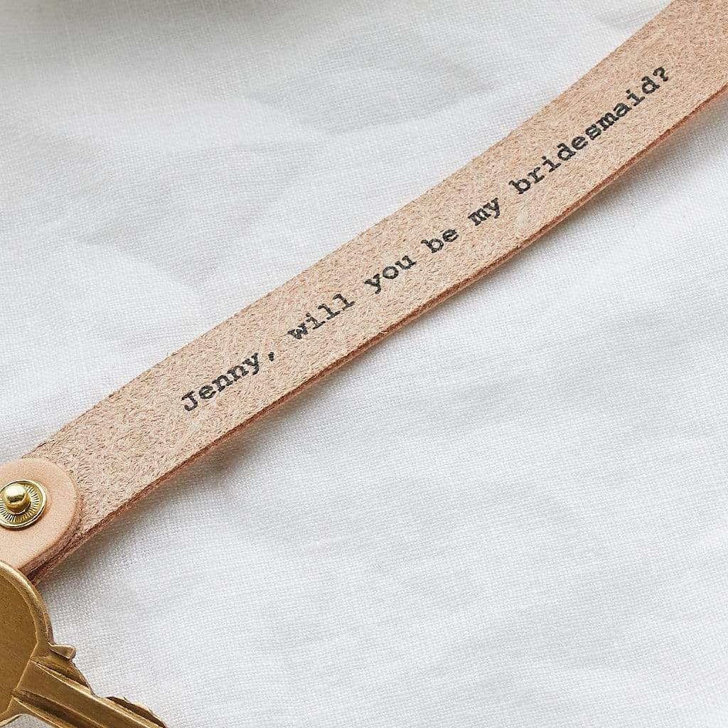 Leather keyring with message printed inside: "Jenny, will you be my bridesmaid?"