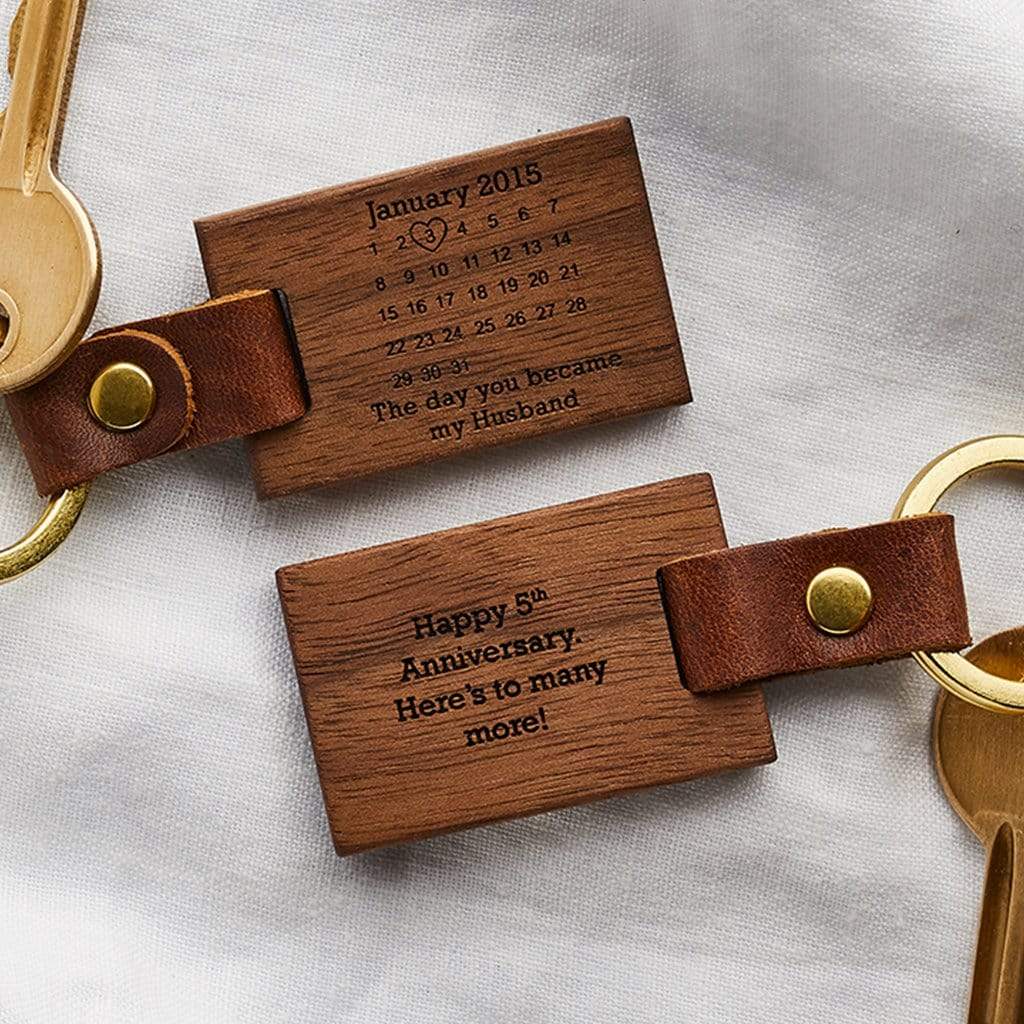 Wooden keyrings engraved with a calendar design and personalised date and message