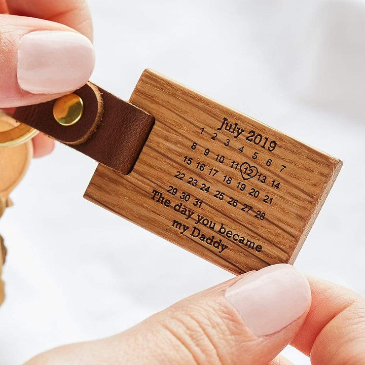 Wooden keyring with an engraved calendar and message 'The day you became my daddy'