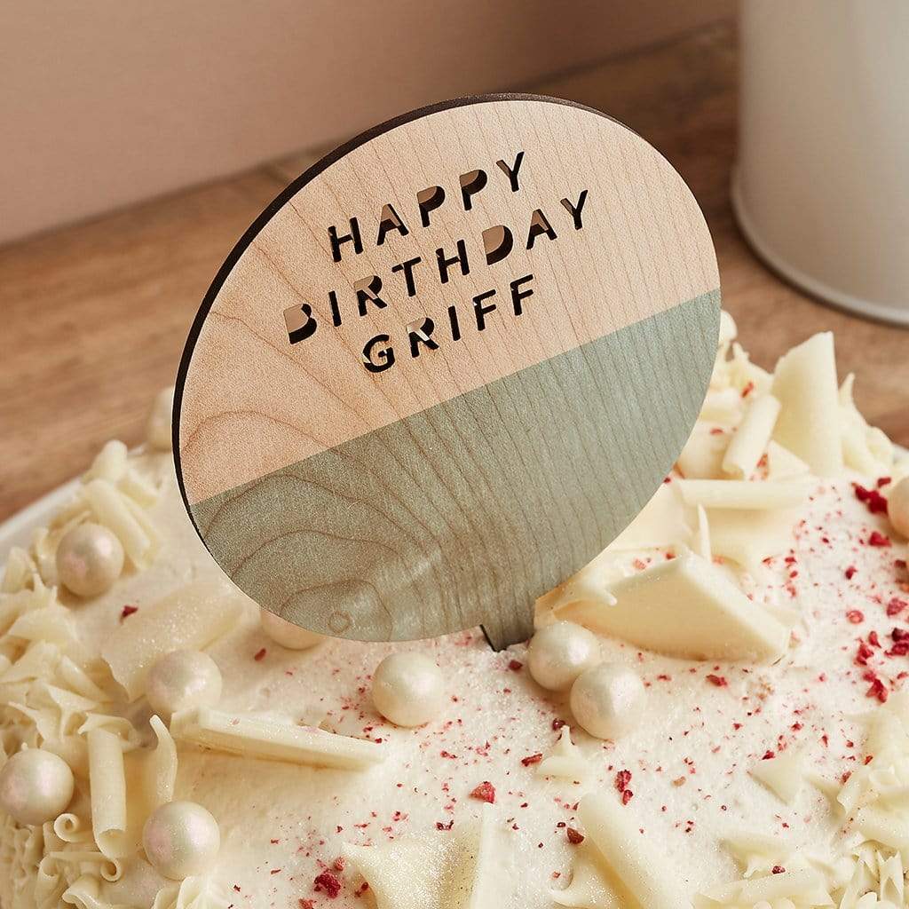 Wooden cake topper engraved 'Happy Birthday Griff', on top of birthday cake
