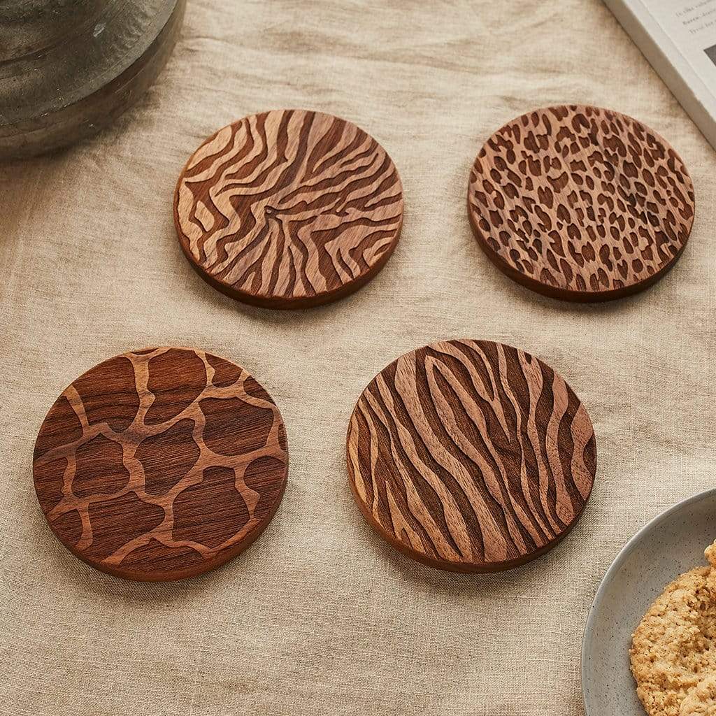 Set of four wooden coasters engraved with animal print patterns